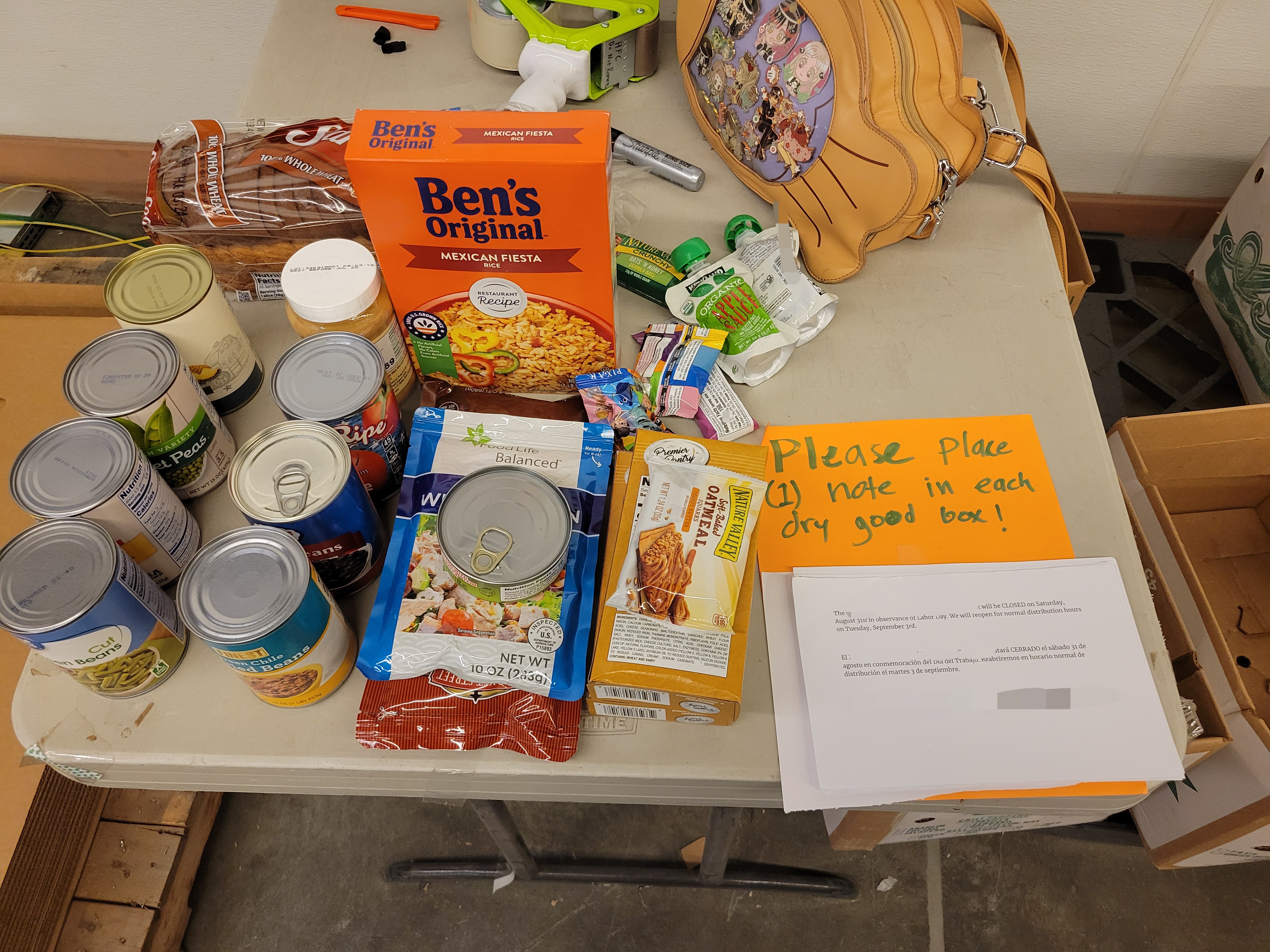 Dry goods with bread and a fish purse behind it on a table.